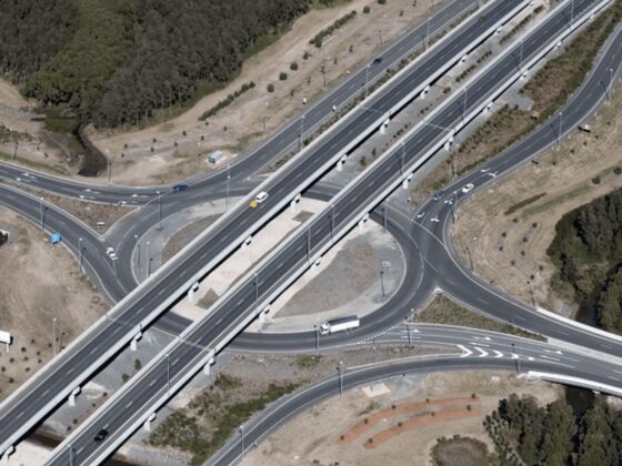 Aerial view of a highway interchange, with overpasses and roundabouts in cleared ground.